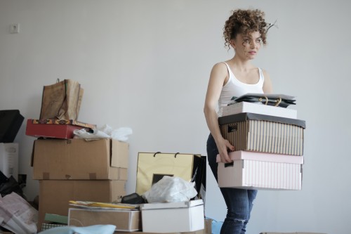 Student moving boxes out of her house.